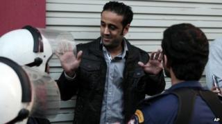Sayed Yousif al-Muhafdha is confronted by security forces personnel in Manama (17 December 2012)