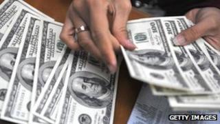 Clerk counts out dollar bills