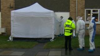 Forensic officers at the scene in Holywell
