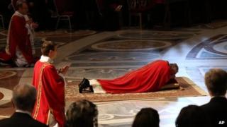 Pope Francis lies down in prayer during the Passion of Christ Mass at St Peter's Basilica, at the Vatican, 29 March 2013