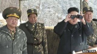 North Korean leader Kim Jong-un (C) watches what the country's media said was a drill of drone planes at an undisclosed location