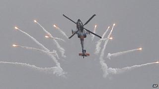 A AH-64 Apache helicopter fires flares during a performance in Poland on 24 August 2013