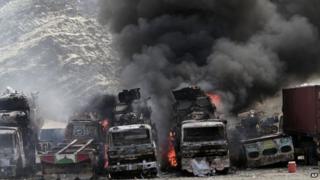 Smoke rises from NATO supply trucks following an attack by militants in the Torkham area near the Pakistan-Afghanistan border in Jalalabad province east of Kabul, Afghanistan, Monday, Sept 2, 2013.