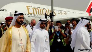 Ruler of Dubai Sheikh Mohammed Bin Rashid al-Maktoum (L) walks past an Emirates Airline's Airbus A380 as he attends the opening ceremony of the Dubai Airshow