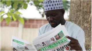 A man read the Nation in Abuja, Nigeria (10 May 2014)