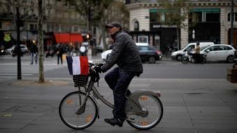 A cyclist carrying a French flag