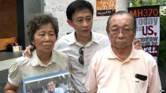 Wong Siew Lian (R) with her son Daniel Tan and husband Tan Tuan Kee (R). Their son and brother Tan Chong Ling was on board MH370