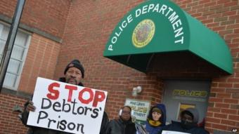 Demonstrators protest outside the police department entrance of the Pine Lawn Municipal Court Building on March 5, 2015 in Pine Lawn, Missouri.