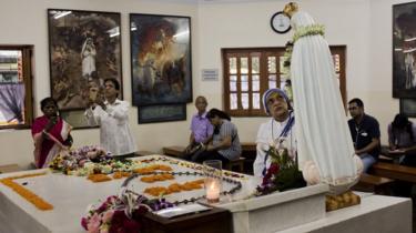 Worshippers gather around the tomb of Mother Teresa inside the Mother house in Kolkata, India, Saturday, September 3