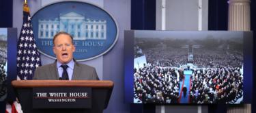 Press Secretary Sean Spicer delivers statement while TV screen shows picture of inauguration. 21 Jan 2017