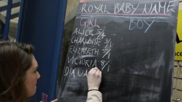 Betting odds are written on a chalkboard outside the Lindo Wing at St Mary's Hospital in London