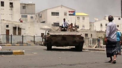 Southern Yemenis stand atop a tank of tribal militiamen loyal to Yemeni President Abdo Rabbo Mansour Hadi following clashes with Houthi fighters in the southern port city of Aden, Yemen