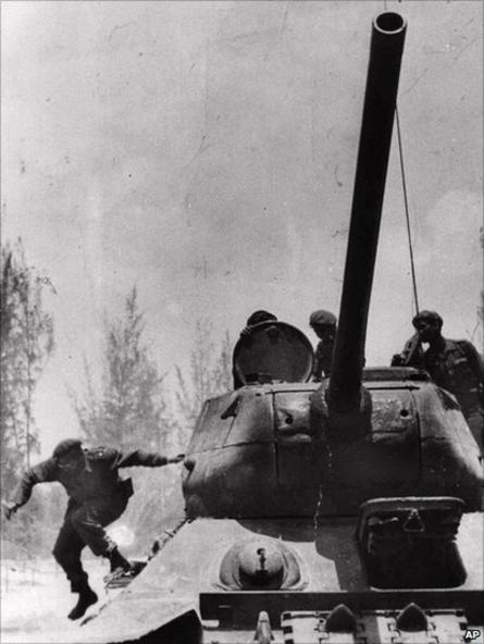 Fidel Castro jumps from a tank as he arrives at Giron, Cuba, near the Bay Of Pigs