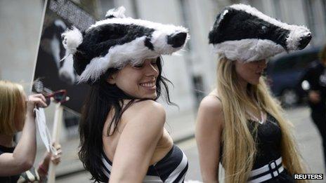Protestors wearing badger head hats