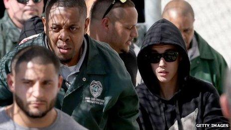 Justin Bieber (R) exits from the Turner Guilford Knight Correctional Centre on January 23, 2014
