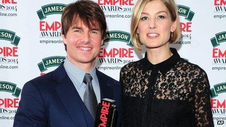 Tom Cruise with his Legend in Our Lifetime award, presented by Rosamund Pike