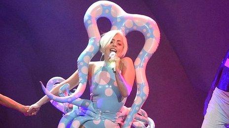 Lady Gaga wearing Dayne Henderson's blue and pink stage costume
