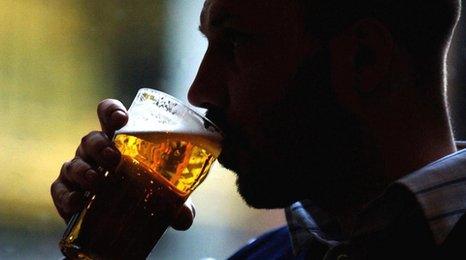 Man drinking beer (posed by a model)