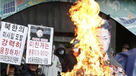 Protestors burn an effigy of the North Korean leader Kim Jong-un after his country's missile launch