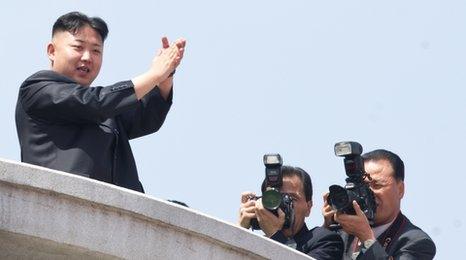 Kim Jong-un applauds during a military parade