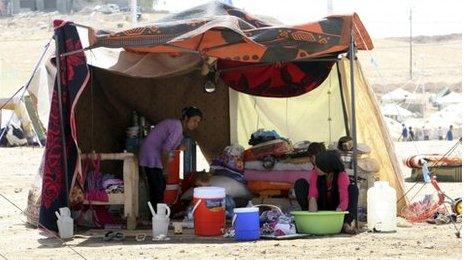 Syrian refugees, who fled the violence in Syria, are seen at a new refugee camp in the outskirts of the city of Arbil in Iraq