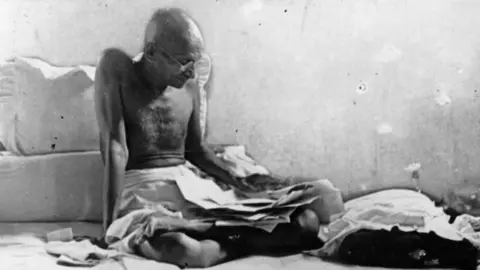 Getty Images Indian statesman Mahatma Gandhi (Mohandas Karamchand Gandhi, 1969 - 1948) fasts in protest against British rule after his release from prison in Poona, India. (Photo by Keystone/Getty Images)