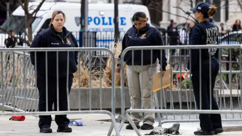 Police inspect a scene in Manhattan after a man poured liquid on himself before setting himself on fire