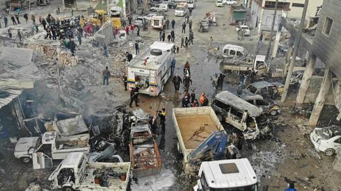 Rescue teams at the site of an air strike on Syria's last major opposition bastion of Idlib on January 15, 2020