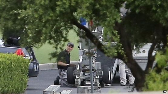 Police appear to setup a remotely operated robot during a stand off with a gunman barricaded inside a van at a Jack in the Box restaurant at Interstate 45 and Dowdy Ferry Road in Hutchins, Texas, 13 June 2015