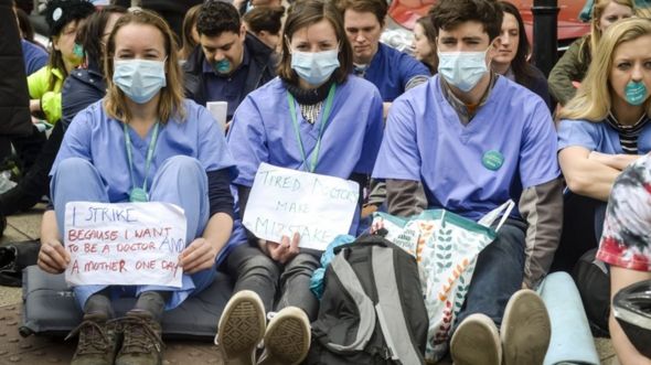 Junior doctors wearing masks in a silent protest