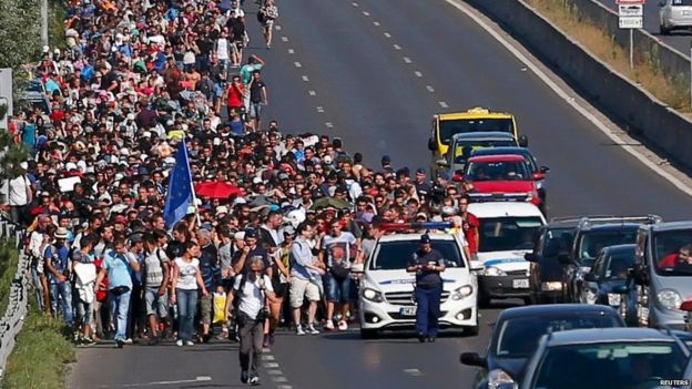 Hundreds of migrants walk along the motorway in Budapest (4 September)
