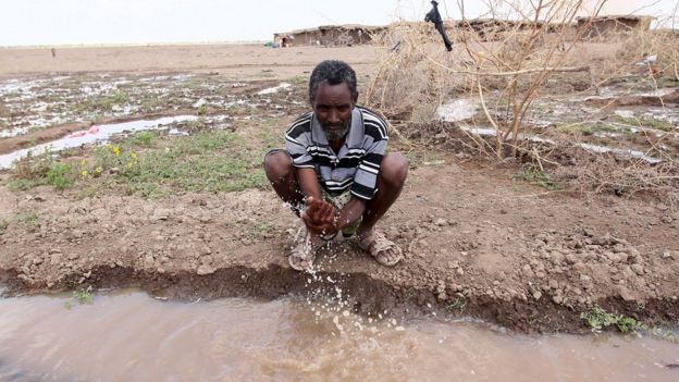 A man washes his hand with running water from a dug-out-trench in the drought stricken Somali region in Ethiopia, January 26, 2016.
