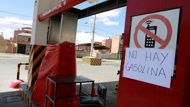 A placard is seen at a closed gas station in El Alto, near La Paz, Bolivia