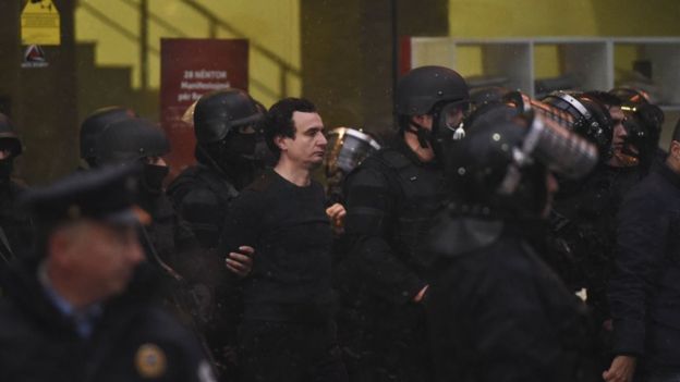Kosovar policemen detain opposition lawmaker Albin Kurti (C) at the Vetevendosje headquarters