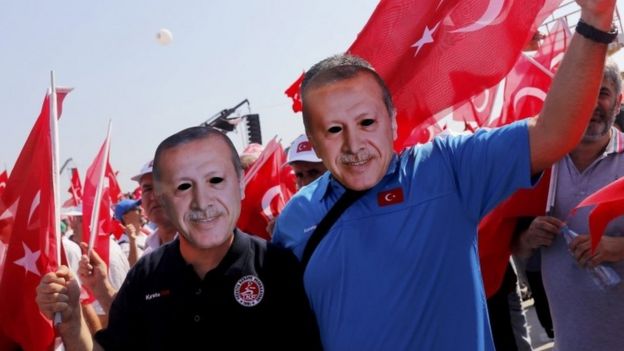 Istanbul anti-coup rally supporters wear Erdogan masks