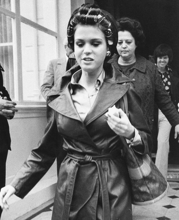 Singer Marie Osmond wearing curlers in her hair, as she leaves Belgrave House Hotel, London, 1975