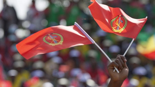 Someone waves the Ethiopian People's Revolutionary Democratic Front flag in front of a large crowd during an election rally in May 2015, Addis Ababa