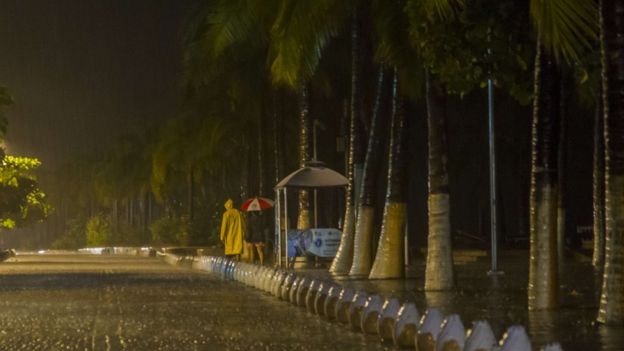 People walk under the rain during the arrival of hurricane Patricia in Puerto Vallarta, Mexico October 23 ,2015.