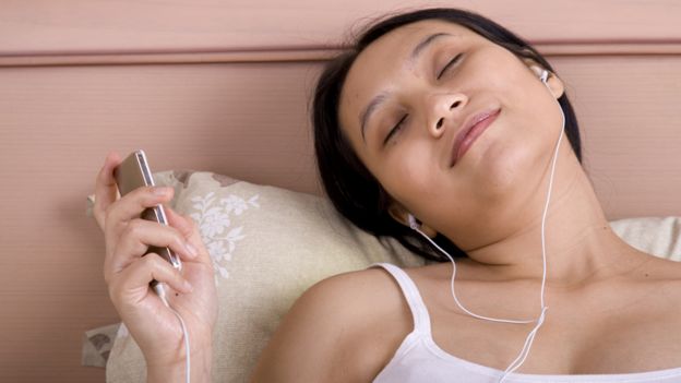 Woman listening to music and looking peaceful