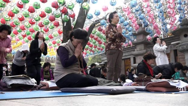 Women praying for good exam results