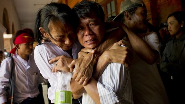 Newly-released political student protester and family members cry after being reunited in Tharrawaddy town, Bago Region in Myanmar on April 8, 2016