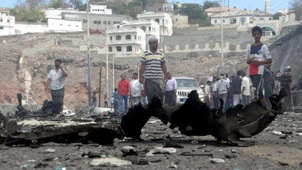 People gather at the site of the car bomb attack