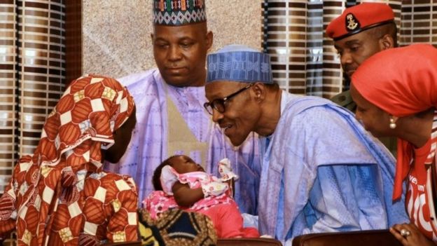 Amina Ali Nkeki with her child, meeting President Buhari