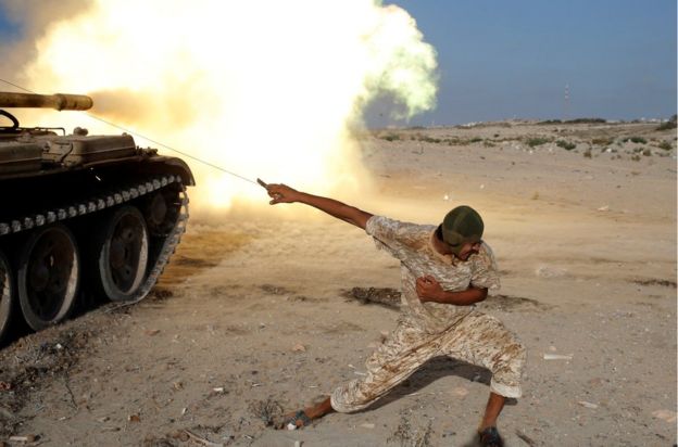 A fighter of Libyan forces allied with the U.N.-backed government fires a shell with Soviet made T-55 tank at Islamic State fighters in Sirte, Libya, August 2, 2016