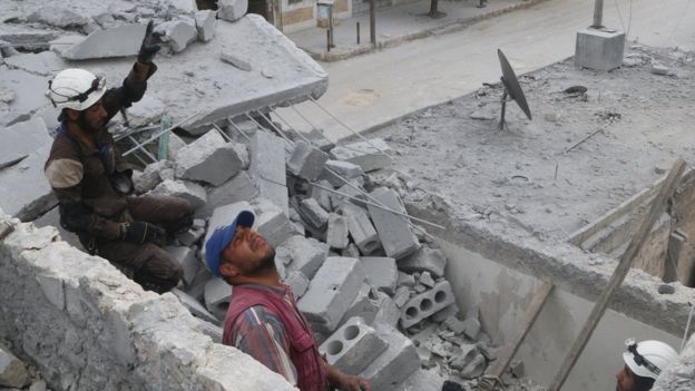 Rescue workers work inside a damaged building after an air strike in the rebel-held Baedeen district of Aleppo, Syria (3 May 2016)