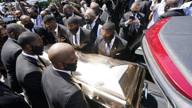 George Floyd's body is loaded into a hearse in Houston, 9 June