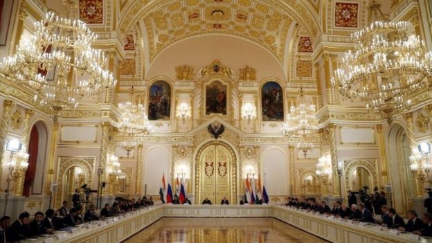 Russian President Vladimir Putin (back, centre-right) and Indian Prime Minister Narendra Modi (back, centre-left) attend a meeting with Russian and Indian businessmen in Moscow Kremlin