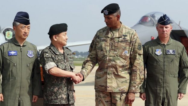 Vincent Brooks, second from right, commander of the United Nations Command, U.S. Forces Korea and Combined Forces Command, shakes hands with South Korean Chairman of the Joint Chiefs of Staff Gen. Lee Sun Jin, second from left
