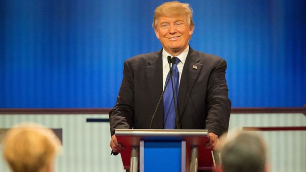 Donald Trump smiles on the stage of a Republican debate in March.