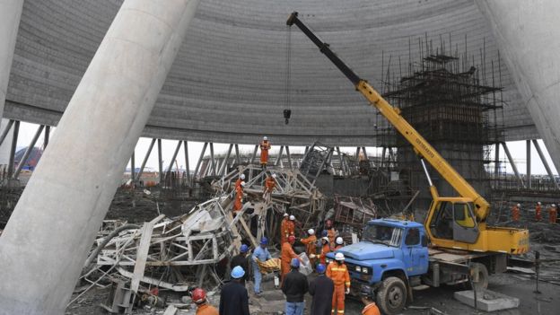 In this photo released by Xinhua News Agency, rescue workers look for survivors after a work platform collapsed at the Fengcheng power plant in eastern China